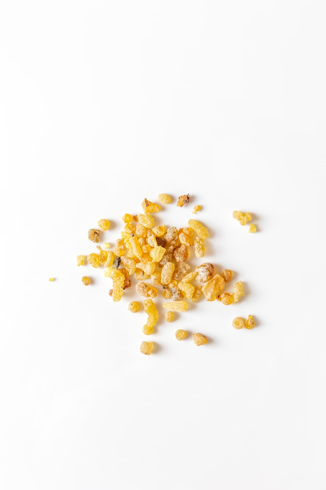 Golden resin pieces on a white surface; botanical identity not specified
